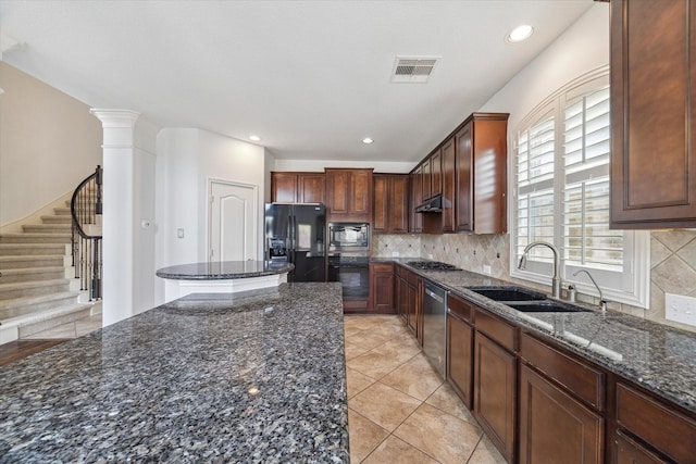 26314 Planters Heath, Katy, TX 77494 - kitchen featuring black appliances, dark stone countertops, under cabinet range hood, decorative backsplash, and a kitchen island