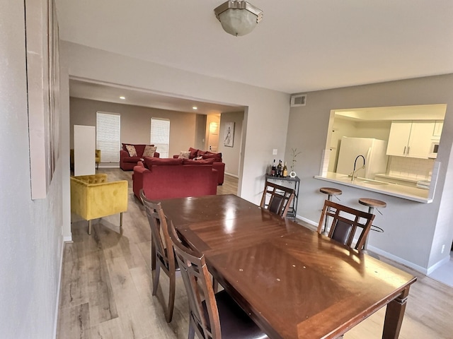 8101 Amelia Rd Unit 407D, Houston, TX 77055 - dining area featuring light wood-style floors and recessed lighting
