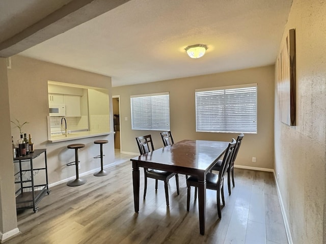 8101 Amelia Rd Unit 407D, Houston, TX 77055 - dining area with wood finished floors and baseboards