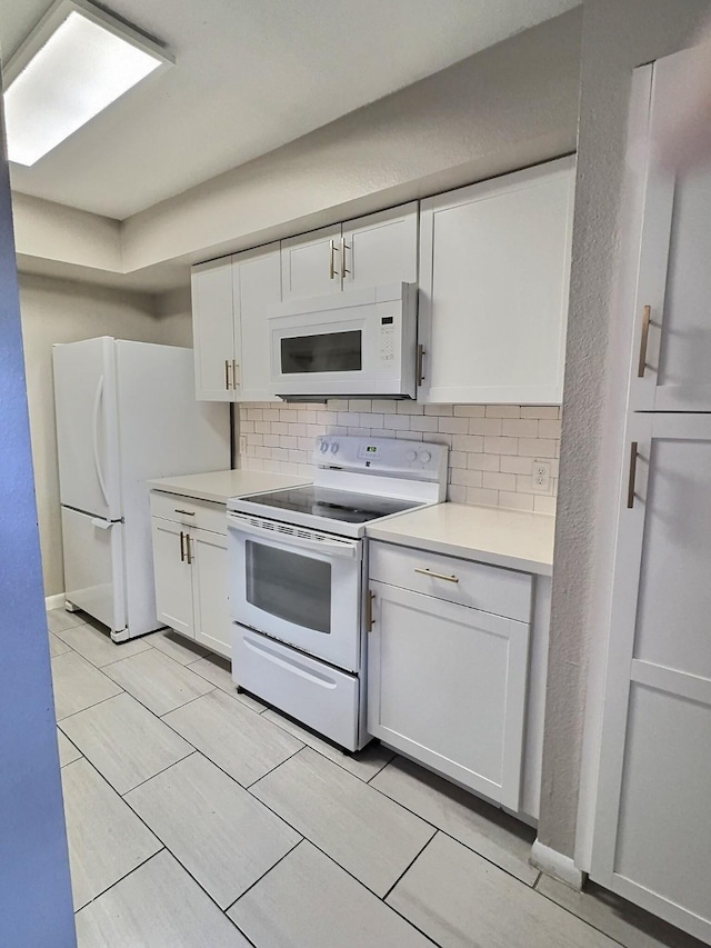 8101 Amelia Rd Unit 407D, Houston, TX 77055 - kitchen with white appliances, backsplash, light countertops, and white cabinets