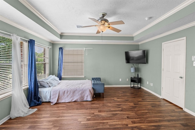 21519 San Marino Dr, Katy, TX 77450 - bedroom with wood finished floors, a textured ceiling, crown molding, a ceiling fan, and a tray ceiling