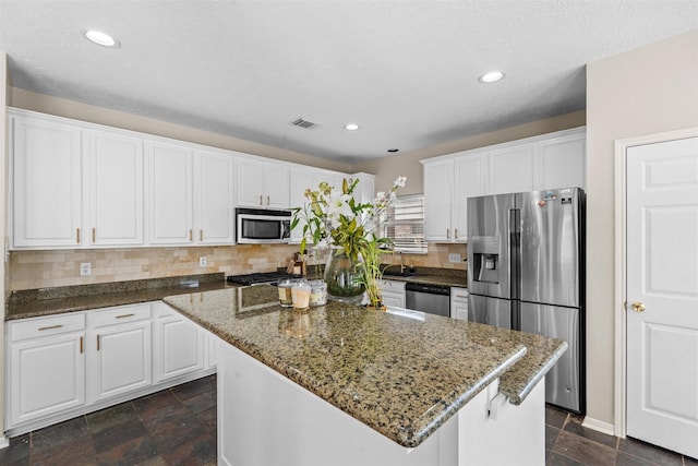 21519 San Marino Dr, Katy, TX 77450 - kitchen with stainless steel appliances, white cabinetry, and recessed lighting