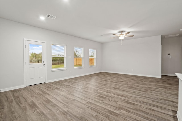 25011 Pomegranate Pl, Montgomery, TX 77316 - unfurnished living room with a ceiling fan and wood finished floors