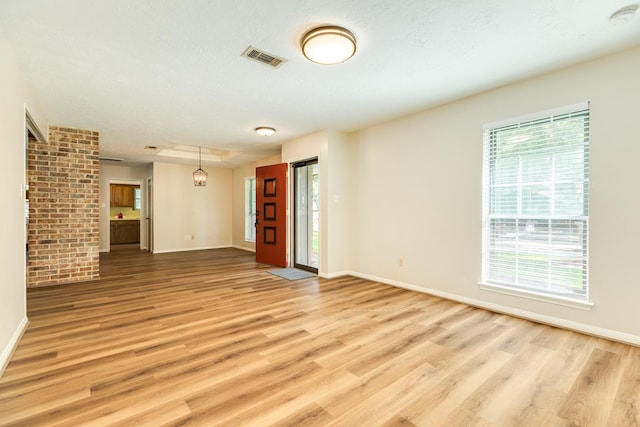 2910 Castle Ct, Pearland, TX 77581 - unfurnished living room featuring plenty of natural light and light wood finished floors