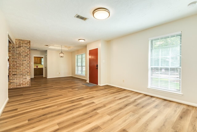 2910 Castle Ct, Pearland, TX 77581 - unfurnished living room with light wood-type flooring and baseboards