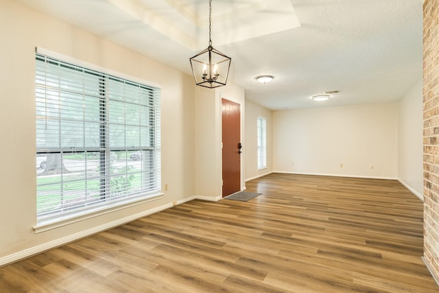 2910 Castle Ct, Pearland, TX 77581 - unfurnished room featuring plenty of natural light, a chandelier, and wood finished floors