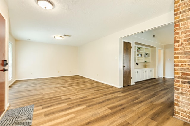 2910 Castle Ct, Pearland, TX 77581 - unfurnished room with wood finished floors and a textured ceiling