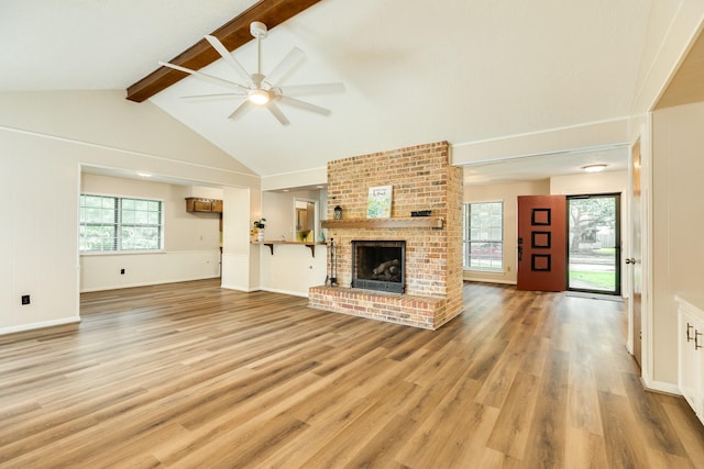 2910 Castle Ct, Pearland, TX 77581 - unfurnished living room featuring ceiling fan, light wood-style flooring, and a brick fireplace