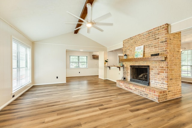 2910 Castle Ct, Pearland, TX 77581 - unfurnished living room featuring ceiling fan, wood finished floors, and a fireplace