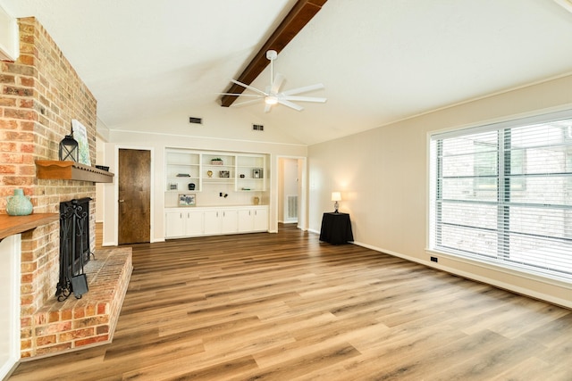 2910 Castle Ct, Pearland, TX 77581 - unfurnished living room with ceiling fan, wood finished floors, a brick fireplace, and built in features
