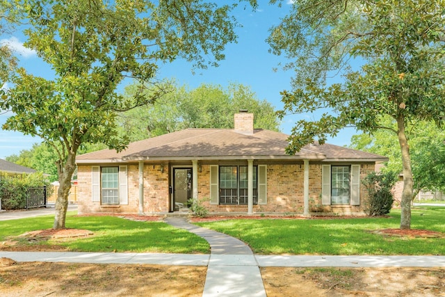 2910 Castle Ct, Pearland, TX 77581 - view of front of property with a chimney, a front lawn, and roof with shingles