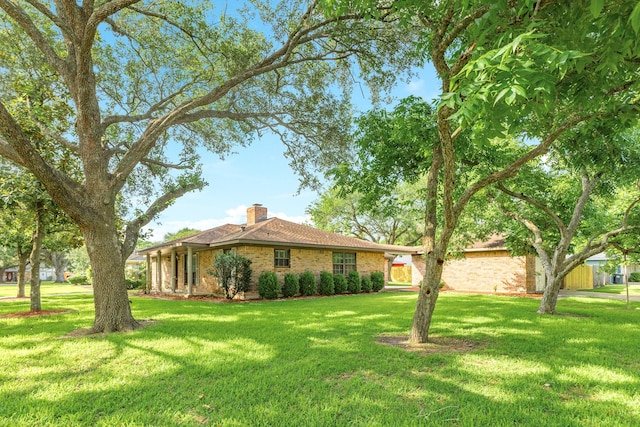 2910 Castle Ct, Pearland, TX 77581 - view of front facade featuring a chimney, a front yard, and brick siding