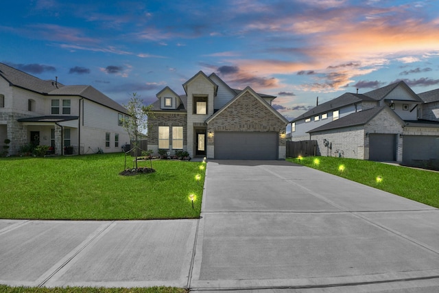 3334 Fogmist Dr, Rosenberg, TX 77471 - view of front facade featuring stone siding, driveway, a lawn, and an attached garage