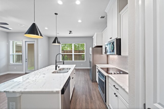 1510 Upland Glen Way, Houston, TX 77043 - kitchen with stainless steel appliances, dark wood-style flooring, a center island with sink, white cabinets, and recessed lighting