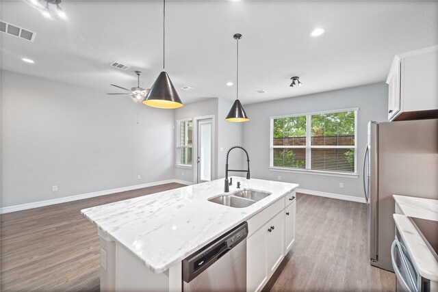 1510 Upland Glen Way, Houston, TX 77043 - kitchen with stainless steel appliances, dark wood-type flooring, an island with sink, white cabinets, and recessed lighting