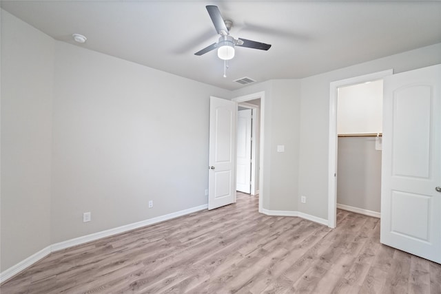 1510 Upland Glen Way, Houston, TX 77043 - unfurnished bedroom with light wood-style floors, a spacious closet, ceiling fan, and a closet