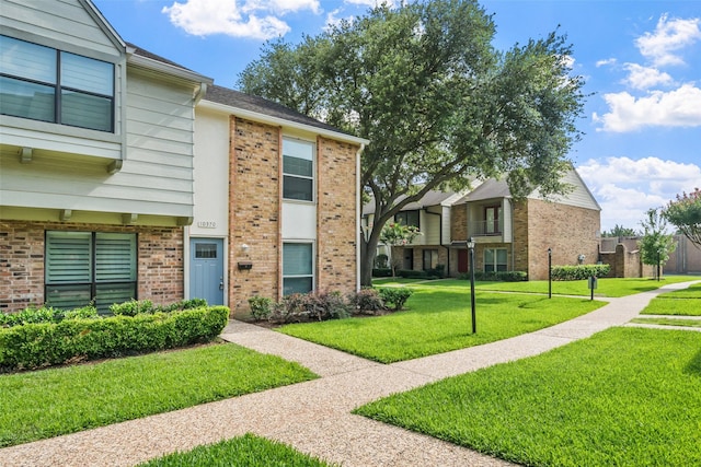 10370 Longmont Dr, Houston, TX 77042 - view of front of home with brick siding and a front lawn