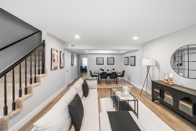 10370 Longmont Dr, Houston, TX 77042 - living area featuring light wood-style flooring, stairs, and recessed lighting