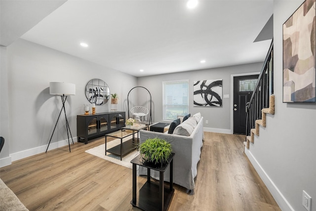 10370 Longmont Dr, Houston, TX 77042 - living area with light wood finished floors, stairway, and recessed lighting