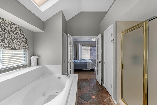 8023 Pine Falls Dr, Houston, TX 77095 - bathroom with ensuite bath, a stall shower, a tub with jets, vaulted ceiling, and a skylight
