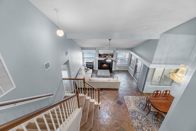 8023 Pine Falls Dr, Houston, TX 77095 - living area with vaulted ceiling, a ceiling fan, and a fireplace
