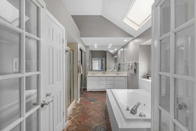 8023 Pine Falls Dr, Houston, TX 77095 - full bath featuring stone tile floors, a jetted tub, double vanity, a shower stall, and lofted ceiling