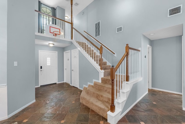 8023 Pine Falls Dr, Houston, TX 77095 - foyer entrance with a high ceiling, stone tile floors, and stairs