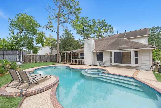 8023 Pine Falls Dr, Houston, TX 77095 - view of swimming pool with a trampoline, a patio, a fenced backyard, and a pool with connected hot tub