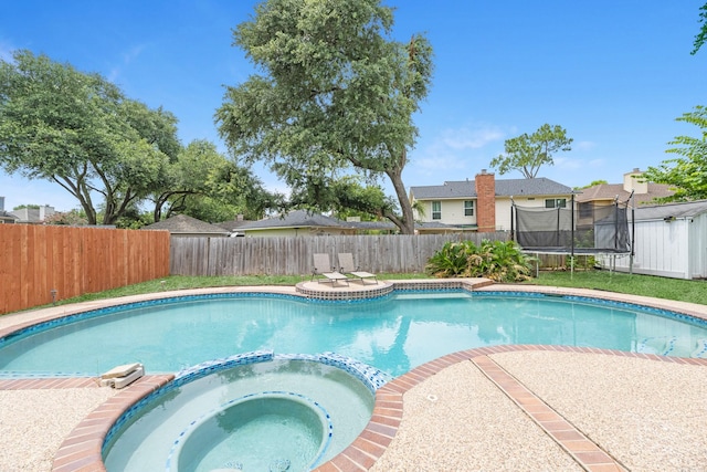 8023 Pine Falls Dr, Houston, TX 77095 - view of swimming pool featuring a trampoline, a pool with connected hot tub, and a fenced backyard