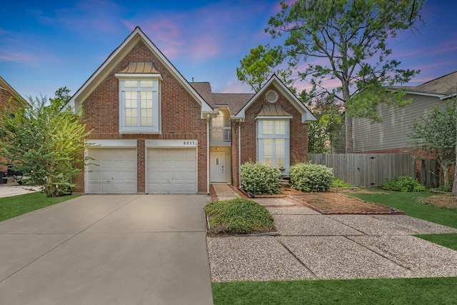 8023 Pine Falls Dr, Houston, TX 77095 - view of front of property featuring driveway, an attached garage, and brick siding