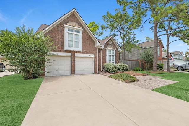 8023 Pine Falls Dr, Houston, TX 77095 - traditional-style house featuring a garage, brick siding, a front yard, and driveway