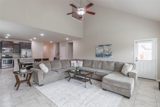 9418 Mcdowell Dr, Richmond, TX 77469 - living area featuring light tile patterned flooring, high vaulted ceiling, stairway, a ceiling fan, and recessed lighting