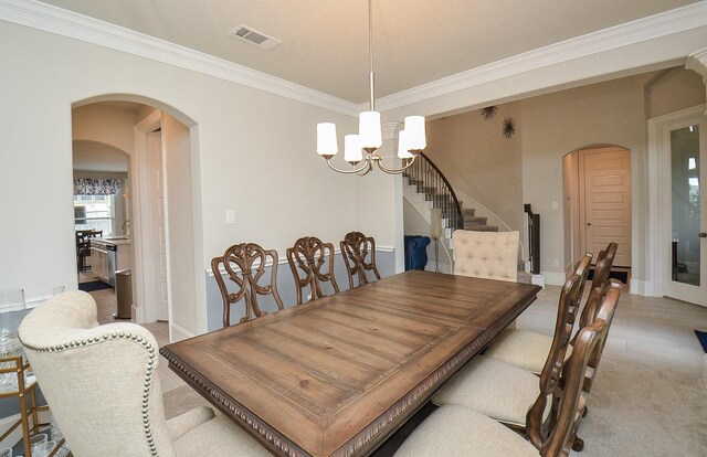 8703 Silver Crest Ln, Missouri City, TX 77459 - dining area with arched walkways, ornamental molding, a chandelier, and stairs