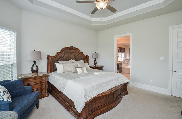 8703 Silver Crest Ln, Missouri City, TX 77459 - bedroom with a raised ceiling, multiple windows, light carpet, crown molding, and ensuite bathroom