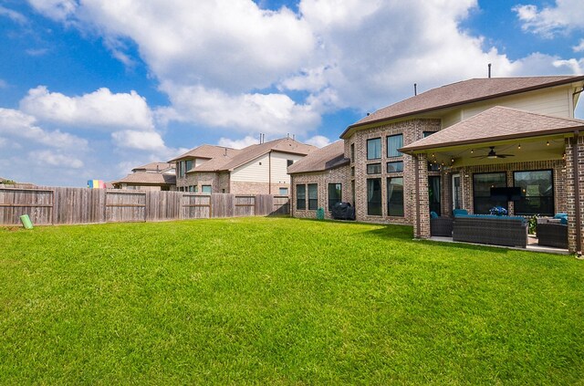 8703 Silver Crest Ln, Missouri City, TX 77459 - fenced backyard featuring an outdoor hangout area, a ceiling fan, and a patio