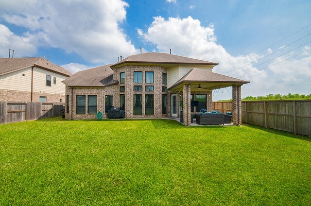 8703 Silver Crest Ln, Missouri City, TX 77459 - rear view of house with an outdoor hangout area, a ceiling fan, brick siding, a fenced backyard, and a patio area