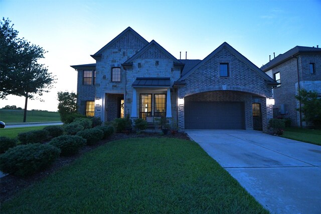 8703 Silver Crest Ln, Missouri City, TX 77459 - french provincial home with a front lawn, driveway, brick siding, and stone siding