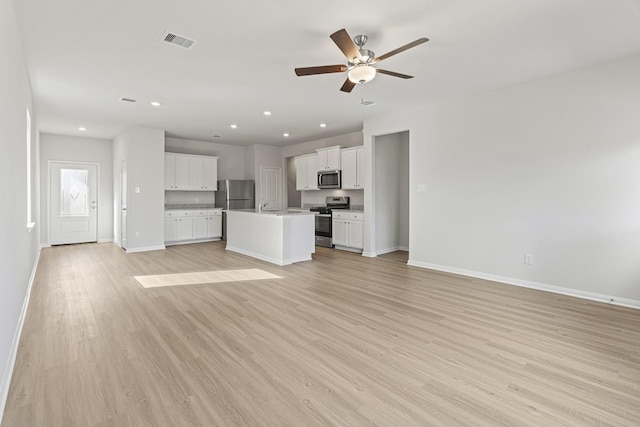 1035 Rosewood Trl, Beasley, TX 77417 - unfurnished living room with light wood-style flooring, ceiling fan, and recessed lighting