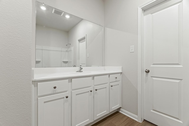 1035 Rosewood Trl, Beasley, TX 77417 - bathroom featuring vanity, wood finished floors, a textured wall, and a shower