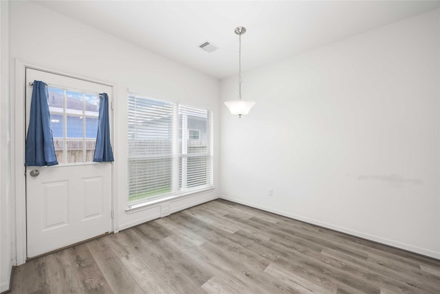 7430 N Star St, Houston, TX 77088 - unfurnished dining area with healthy amount of natural light and wood finished floors