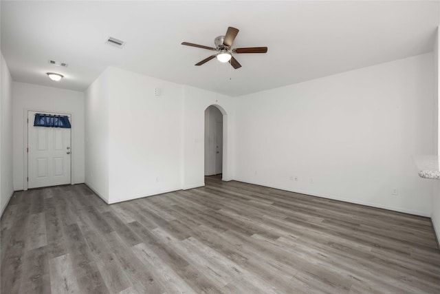 7430 N Star St, Houston, TX 77088 - unfurnished room featuring arched walkways, wood finished floors, and ceiling fan
