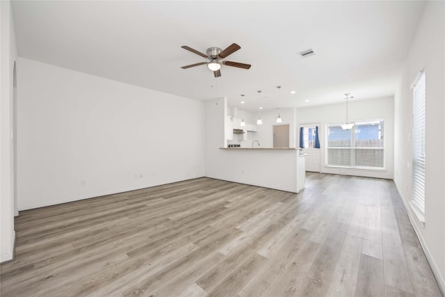 7430 N Star St, Houston, TX 77088 - unfurnished living room with light wood-style floors, ceiling fan, and recessed lighting