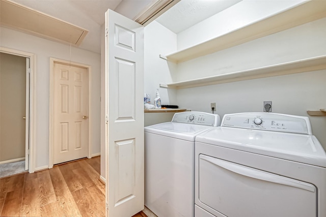 5007 Maple Brook Ln, Kingwood, TX 77345 - washroom with separate washer and dryer, attic access, and light wood-style flooring
