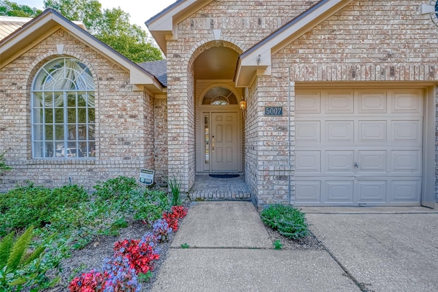 5007 Maple Brook Ln, Kingwood, TX 77345 - entrance to property with brick siding, an attached garage, and concrete driveway
