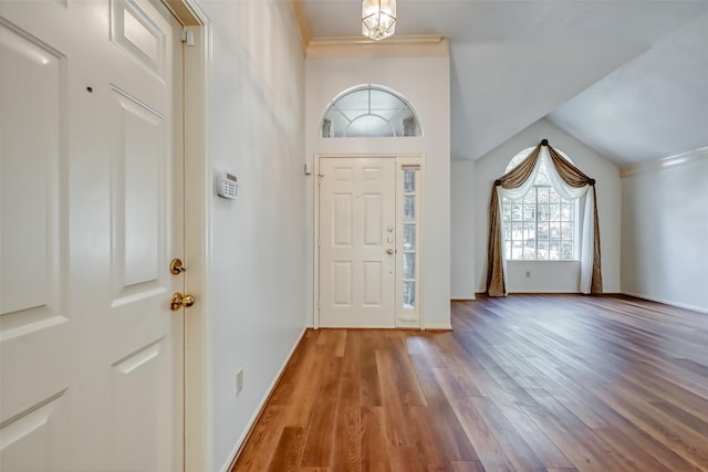 5007 Maple Brook Ln, Kingwood, TX 77345 - entryway featuring ornamental molding, wood finished floors, and lofted ceiling