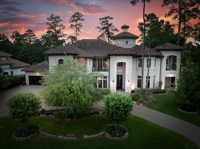 2 N Badger Lodge Cir, The Woodlands, TX 77389 - mediterranean / spanish house featuring a garage, driveway, a front yard, and stucco siding
