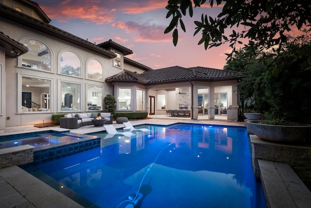 2 N Badger Lodge Cir, The Woodlands, TX 77389 - pool at dusk featuring a patio, a pool with connected hot tub, and french doors