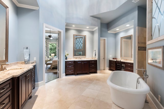 2 N Badger Lodge Cir, The Woodlands, TX 77389 - ensuite bathroom featuring crown molding, two vanities, a freestanding tub, a ceiling fan, and a high ceiling