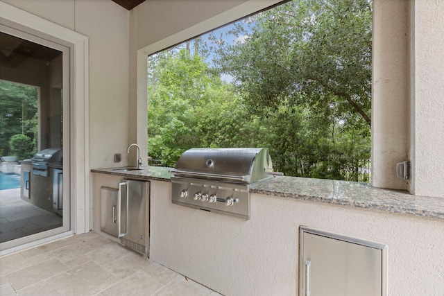 2 N Badger Lodge Cir, The Woodlands, TX 77389 - view of patio / terrace with exterior kitchen and a sink