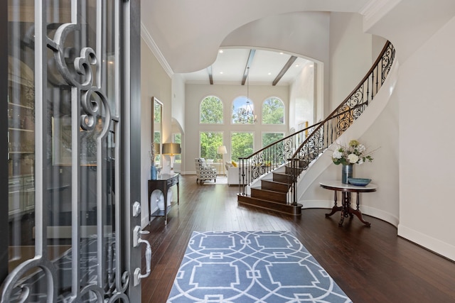 2 N Badger Lodge Cir, The Woodlands, TX 77389 - foyer entrance with hardwood / wood-style floors, stairway, a towering ceiling, arched walkways, and ornamental molding